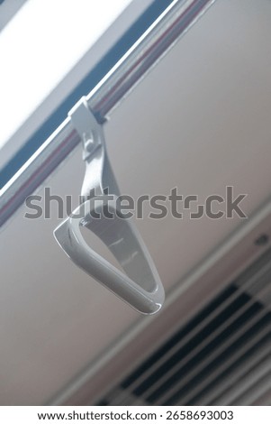 Hand grip inside the train of SRT Dark Red Line. It is a rapid transit line operated as part of the MBTA subway system from Bangkok to Rangsit