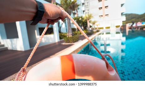 Hand grip ring buoy robe near swimming pools in evening - Shutterstock ID 1399988375