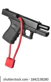 A hand gun firearm is locked with a safety cable to prevent anyone from firing the weapon.