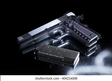 Hand Gun Pistol Against A Dark Background