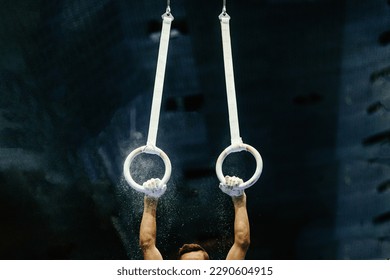 hand gymnast performing on ring frame competition artistic gymnastics, grips rings and gym chalk - Powered by Shutterstock