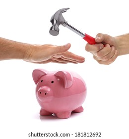 Hand With Hammer About To Smash Piggy Bank To Get At Savings Being Protected By Another Hand Concept For Protecting Your Assets, Financial Help And Insurance