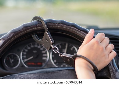 The hand is handcuffed to the steering wheel of the car on the track. Dependence of fast driving
