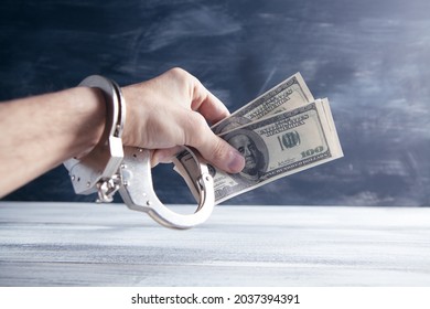 Hand In Handcuffs Holding Money