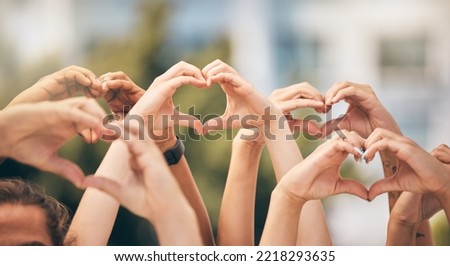 Hand, heart and love with a group of people making a sign with their hands outdoor together in the day. Crowd, freedom and community with man and woman friends doing a gesture to promote health