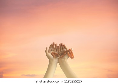 hand heaven concept empty space confession beg for forgiveness,Empty hands pray for mercy for God The symbol of humility in Ramadan,Muslim boy holding tasbih perform ritual in front of mosque