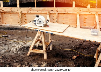 Hand held circular saw on workbench - Powered by Shutterstock