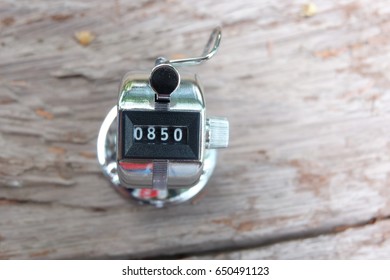 hand held counter on the old wooden table with nice background
