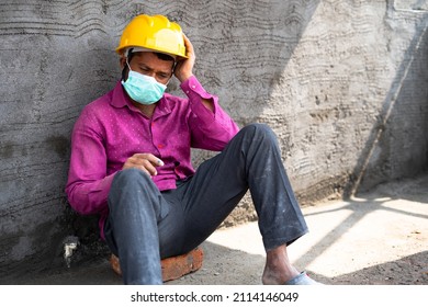 Hand Held Pan Shot Of Worried Construction Labour With Medical Fask At Site - Concept Of Job Loss, Debtedness And Lonely During Coronavirus Or Cocivd-19 Pandemic Lockdown