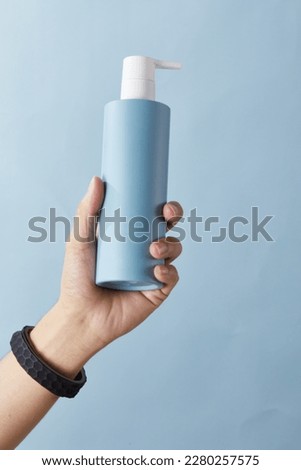 Hand held skin care products Blue product Body wash Press cream