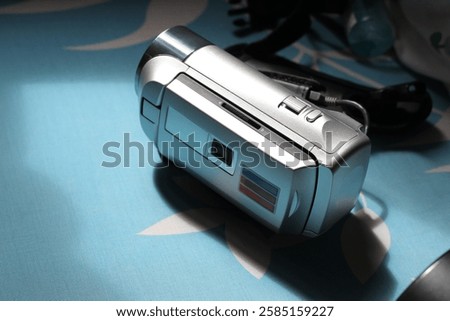 A hand held small video camera also known as handy-cam