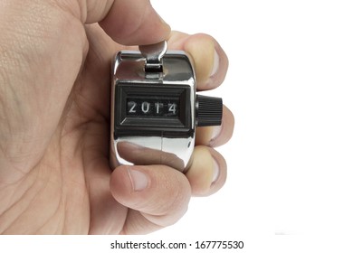 Hand held tally counter showing 2014 holded by male hand isolated on white background