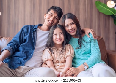 Hand Hello Gesture With Cheerful Smiling Portrait Asian Parent And Daughter Look At Camera Together,asian Familly Stay Home Together Hand Waving Say Hi On Sofa In Living Room Happy Peaceful Stay Home 