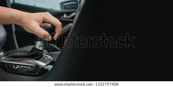 hand hold\
automatic transmission car lever. driving automobile with automatic\
gears and copy space for\
text.