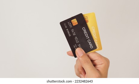 Hand is hold black and gold credit card on white background.Two credit card.	 - Shutterstock ID 2232482643