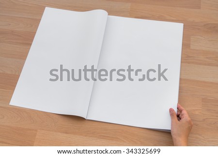 Hand hold Blank Newspaper with empty space mock up on wood background