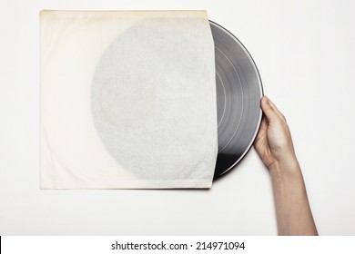 Hand Hold The Disk(LP, Record) With Paper Sleeve Isolated White.