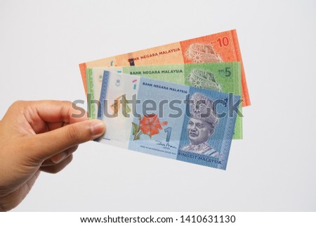 Hand hold each banknote of Ringgit Malaysia 1,  Ringgit Malaysia 5 and Ringgit Malaysia 10