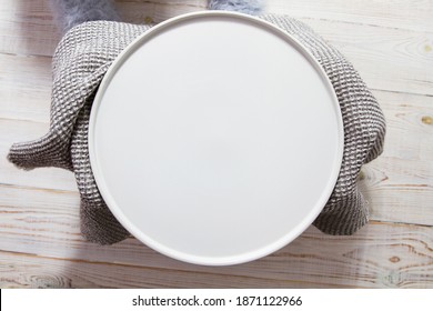 Hand Hold Empty Plate Closeup. Empty White Circle Plate On Wooden Table With Linen Napkin. Overhead View, Mock Up.