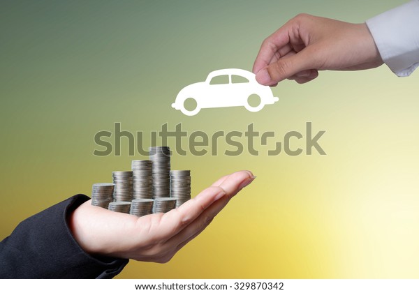 Hand hold money to change the\
car on light dark background , business idea and finance\
concept