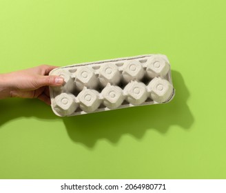 Hand Hold Paper Rectangular Tray For Chicken Eggs On A Green Background, Close Up