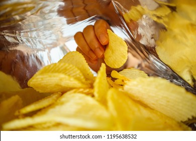 Hand Hold Potato Chips Inside Snack Foil Bag