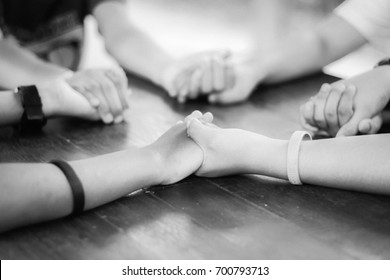 Hand Hold Praying Family. Father Mother Daughter And Son Holding Hand And Pray In The Table. Black.