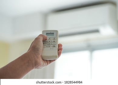 hand hold remote control air conditioner  - Shutterstock ID 1828544984