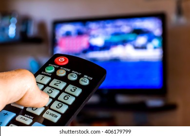 Hand Hold The Remote Control To Change Channels On Tv