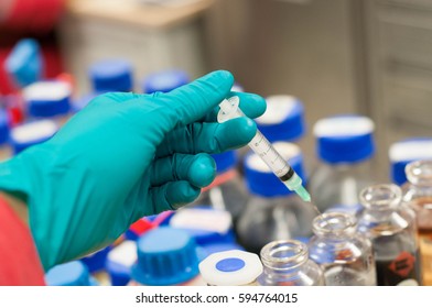 Hand Hold Syringes And The Crude Oil Sample Bottle.selective Focus