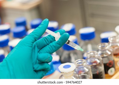 Hand Hold Syringes And The Crude Oil Sample Bottle.selective Focus