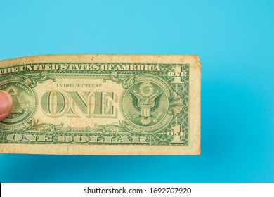 Hand hold USA One dollar banknote isolated on Blue background