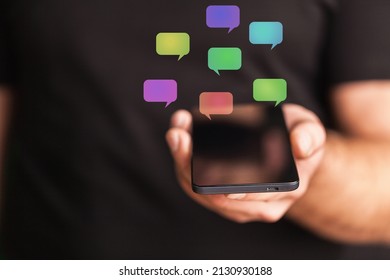A hand hold using smartphone with chat icon flying, technology business - Shutterstock ID 2130930188