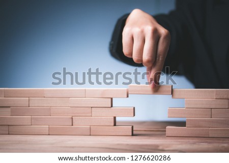 hand hold wood bridge Create stability for the company block risk