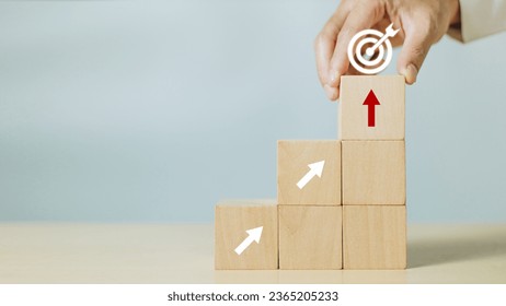 Hand hold wooden cube with icon target and arrows pointing up to target. Concept of business success growth increase up - Shutterstock ID 2365205233