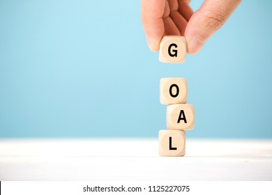 Hand hold wooden cubes with GOAL word. Business success goal concept. - Shutterstock ID 1125227075
