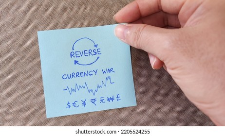 Hand Holdinf A Note Showing Reverse Currency War Concept
