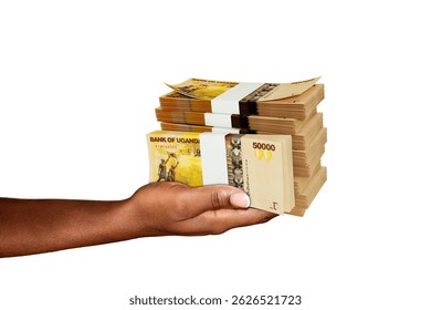 Hand Holding 3D rendering of stacks of Ugandan shilling notes isolated on white background