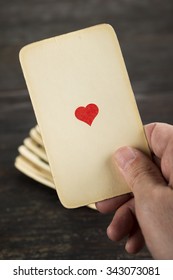 Hand Holding Ace Of Hearts Catch From The Deck