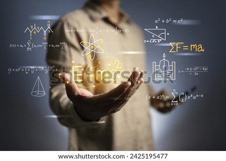 Hand holding albert einstein equation is general of relativity E equal to m c square is one of physics theory