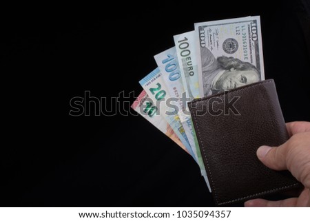 Hand holding American dollar  banknotes isolated on black background