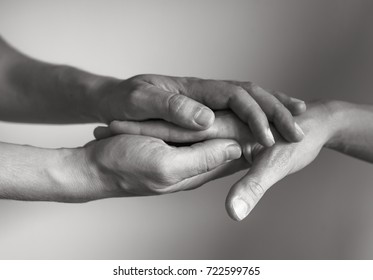 Hand holding another hand. People helping and comforting each other concept.