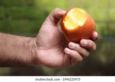 Hand Holding Apple Fruit With Bite Mark