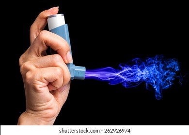 Hand Holding Asthma Inhaler With Smoke On Black Background