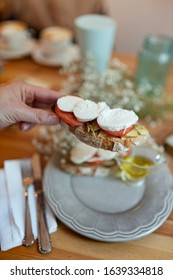 Hand Holding Avocado Toast And Fresh Cheese