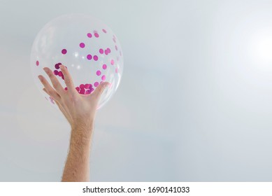 Hand Holding Balloon With Brightness Background