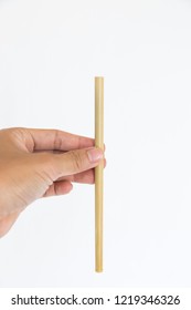 Hand Holding Bamboo Drinking Straw Isolated On White Background.