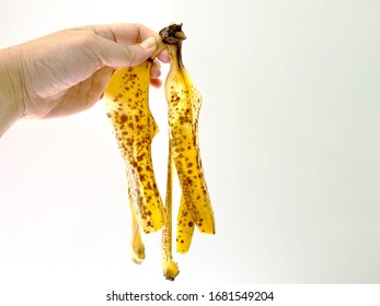 Hand Holding Banana Peel On White Background