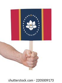 Hand Holding Banner On Wood Stick, Isolated - Flag Of Mississippi