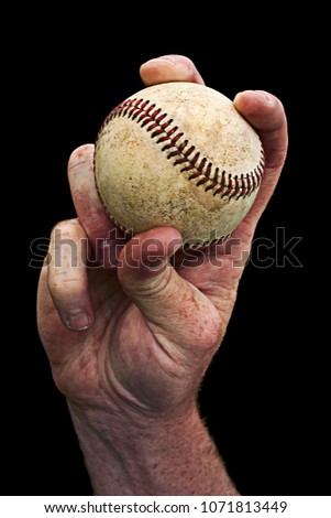 Hand holding a baseball in a fastball grip